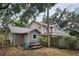 Back exterior of home featuring a fenced yard and covered deck at 26 Weston Rd, Leesburg, FL 34748