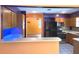 View of the kitchen with an orange color scheme from the serving counter at 26 Weston Rd, Leesburg, FL 34748