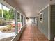 Lanai includes a view of hot tub, wooden fence and well-manicured backyard at 26 Weston Rd, Leesburg, FL 34748