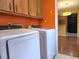 Updated laundry area with overhead cabinets and modern washer and dryer at 26 Weston Rd, Leesburg, FL 34748