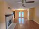 Spacious living room features a cozy fireplace, wood floors, and double doors to the outdoor area at 26 Weston Rd, Leesburg, FL 34748