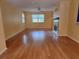 Open-concept living room featuring wood floors, a cozy fireplace, and plenty of natural light at 26 Weston Rd, Leesburg, FL 34748