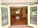 Open living room with hardwood floors and views of the screened-in lanai at 26 Weston Rd, Leesburg, FL 34748