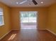 Living room shows sliding glass doors leading to lanai and backyard at 26 Weston Rd, Leesburg, FL 34748
