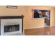 Cozy living room featuring a fireplace with views to kitchen at 26 Weston Rd, Leesburg, FL 34748