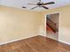Spacious room with hardwood floors, ceiling fan, and staircase access at 26 Weston Rd, Leesburg, FL 34748