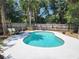 Private pool surrounded by lush landscaping and a wooden fence, creates a serene escape at 26 Weston Rd, Leesburg, FL 34748