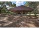 A large open barn has multiple stalls and room for storage and riding at 27011 Se Highway 42, Umatilla, FL 32784