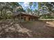 Stall barn with multiple horse stalls surrounded by a spacious, wooded area at 27011 Se Highway 42, Umatilla, FL 32784