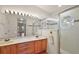 Bright bathroom with double sink vanity and glass-enclosed shower at 27011 Se Highway 42, Umatilla, FL 32784