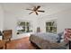 Cozy bedroom features a lake view and terracotta tile flooring at 27011 Se Highway 42, Umatilla, FL 32784