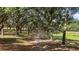 Tree-lined driveway through a tranquil wooded area, creating a picturesque entrance to the property at 27011 Se Highway 42, Umatilla, FL 32784