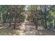 Gated entrance to Fox Run, leading to a tree-lined drive at 27011 Se Highway 42, Umatilla, FL 32784