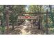 A picturesque entrance marked by a 'Fox Run' sign, inviting you into a private tree-lined property at 27011 Se Highway 42, Umatilla, FL 32784
