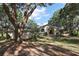 Charming home with arched entryway, lush landscaping, and a well-maintained lawn at 27011 Se Highway 42, Umatilla, FL 32784
