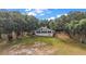 A-frame home nestled among mature trees, offering natural light through its many windows and a peaceful retreat at 27011 Se Highway 42, Umatilla, FL 32784