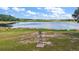 Serene view of a tranquil lake with a vintage windmill creating a peaceful, rustic atmosphere at 27011 Se Highway 42, Umatilla, FL 32784