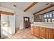 Traditional kitchen features terracotta tile floor and wood cabinets at 27011 Se Highway 42, Umatilla, FL 32784