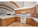 Functional kitchen with light wood cabinets, tile counters, and tiled floors at 27011 Se Highway 42, Umatilla, FL 32784