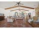 Open-concept living room featuring tiled floors, bright windows, and vaulted ceilings at 27011 Se Highway 42, Umatilla, FL 32784