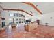 Spacious living room with a stone fireplace, terra cotta tile flooring, and a wall of French doors to the outside at 27011 Se Highway 42, Umatilla, FL 32784