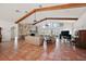 Expansive living room featuring tile flooring, vaulted ceiling, and stone fireplace at 27011 Se Highway 42, Umatilla, FL 32784