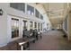 Enclosed porch showcasing comfortable seating, brick flooring, a high ceiling, and large windows overlooking lush scenery at 27011 Se Highway 42, Umatilla, FL 32784