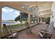 A screened porch with brick flooring offers serene water views and ample space for relaxation at 27011 Se Highway 42, Umatilla, FL 32784