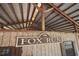 Rustic barn interior featuring 'Fox Run' sign, wooden beams, and metal roof, showcasing the property's charming character at 27011 Se Highway 42, Umatilla, FL 32784