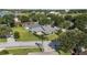 Home features a well-manicured lawn, mature landscaping, and a brick-accented exterior at 2750 Coral Reef Way, Tavares, FL 32778