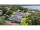 Home features a well-manicured lawn, mature landscaping, and a brick-accented exterior at 2750 Coral Reef Way, Tavares, FL 32778