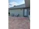 Relaxing back patio area with outdoor seating and a convenient door leading inside the residence at 2750 Coral Reef Way, Tavares, FL 32778