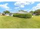 Expansive backyard featuring lush lawn and mature hedges providing privacy at 2750 Coral Reef Way, Tavares, FL 32778