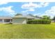 Well-maintained backyard featuring a lush green lawn and privacy landscaping at 2750 Coral Reef Way, Tavares, FL 32778