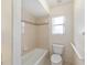 Bathroom features a bathtub, toilet, and window, designed for comfort and convenience at 2750 Coral Reef Way, Tavares, FL 32778