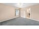 Neutral bedroom featuring carpet flooring, ceiling fan, and window at 2750 Coral Reef Way, Tavares, FL 32778