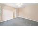 Neutral bedroom featuring carpet flooring, ceiling fan, and door to closet at 2750 Coral Reef Way, Tavares, FL 32778