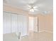 Neutral bedroom featuring tile floors, ceiling fan, and closet at 2750 Coral Reef Way, Tavares, FL 32778