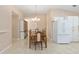 Charming dining area with wooden table set, chandelier lighting, and easy access to the kitchen and living spaces at 2750 Coral Reef Way, Tavares, FL 32778