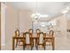 Open dining room with large table, leading to the kitchen, great natural light and fan at 2750 Coral Reef Way, Tavares, FL 32778