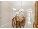 View of the dining room leading to the front door with a decorative chandelier and natural light at 2750 Coral Reef Way, Tavares, FL 32778