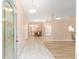 Inviting entryway featuring a decorative glass door and tiled flooring that flows into an open-concept dining and kitchen area at 2750 Coral Reef Way, Tavares, FL 32778