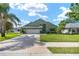 Charming home with a well-maintained lawn, two car garage, and a driveway at 2750 Coral Reef Way, Tavares, FL 32778