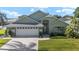 Charming home with a well-maintained lawn, two car garage, and a driveway at 2750 Coral Reef Way, Tavares, FL 32778