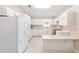 Functional kitchen featuring ample cabinet space, stainless steel appliances, and a peninsula counter for added convenience at 2750 Coral Reef Way, Tavares, FL 32778