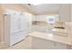 Bright kitchen with white cabinets, appliances, and ample counter space for meal preparation at 2750 Coral Reef Way, Tavares, FL 32778