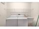 Laundry room featuring washer, dryer, utility sink, and shelving at 2750 Coral Reef Way, Tavares, FL 32778