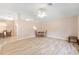 Bright living room with wood floors, neutral walls, ceiling fan, and adjacent dining area for seamless entertaining at 2750 Coral Reef Way, Tavares, FL 32778