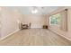 Spacious living room featuring wood floors, large windows for natural light, and a ceiling fan for added comfort at 2750 Coral Reef Way, Tavares, FL 32778