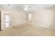Spacious main bedroom with carpet, and access to ensuite bathroom and large closet at 2750 Coral Reef Way, Tavares, FL 32778